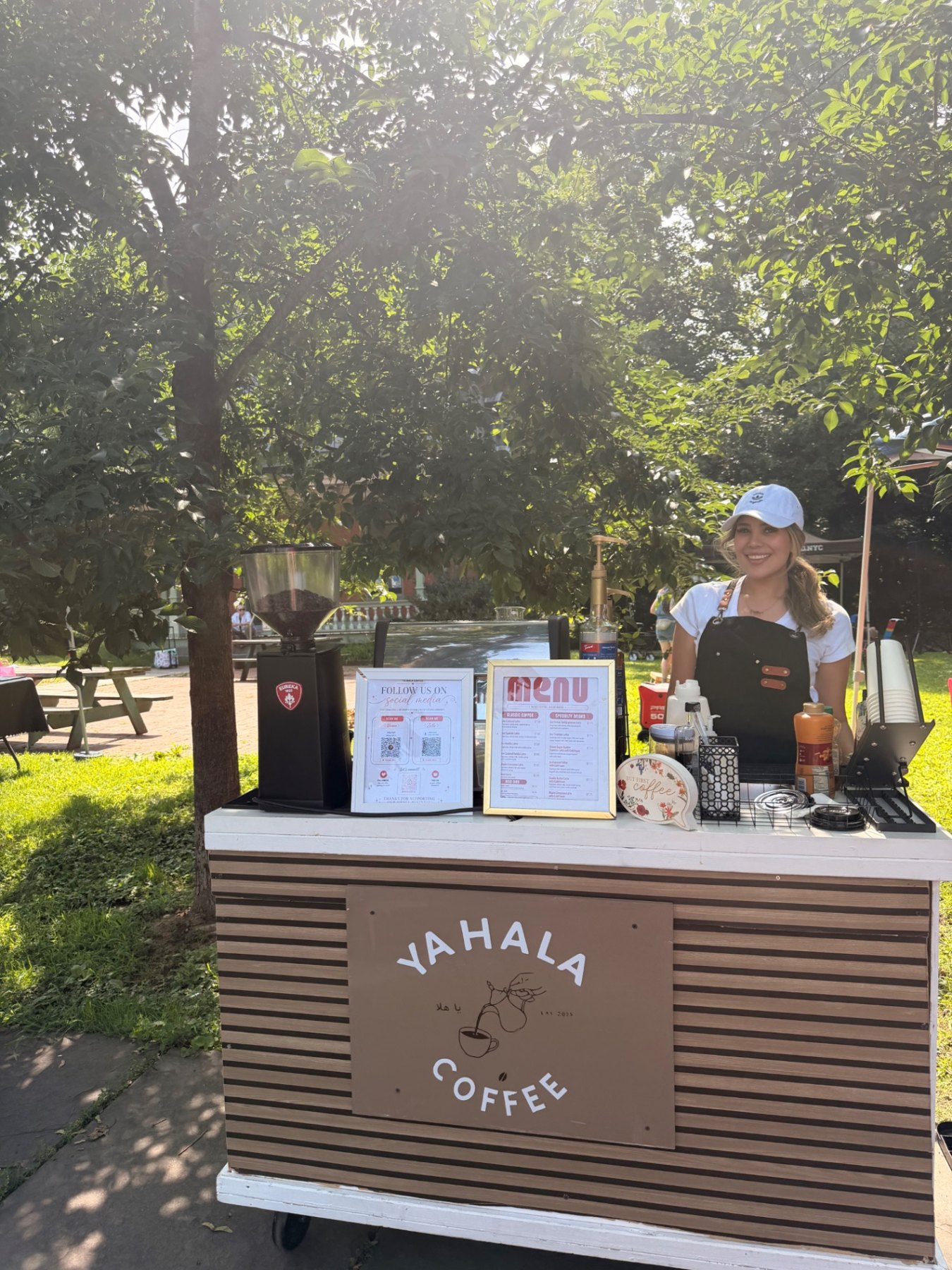 The barista at the Ya Hala Coffee cart counter